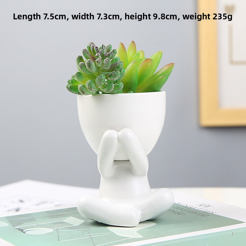 Black lazy person's small potted plant