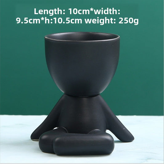 Black lazy person's small potted plant