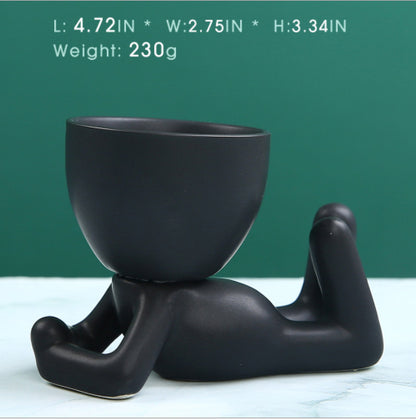Black lazy person's small potted plant