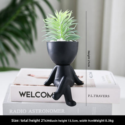 Black lazy person's small potted plant