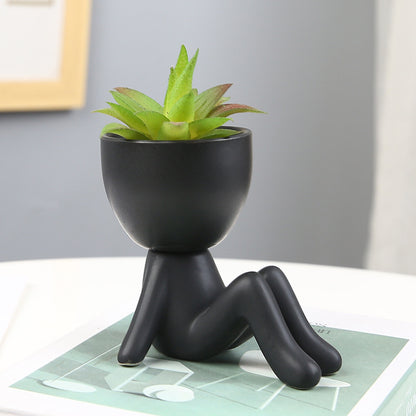 Black lazy person's small potted plant