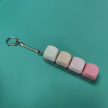 Button-operated stress-relieving toy keychain pendant