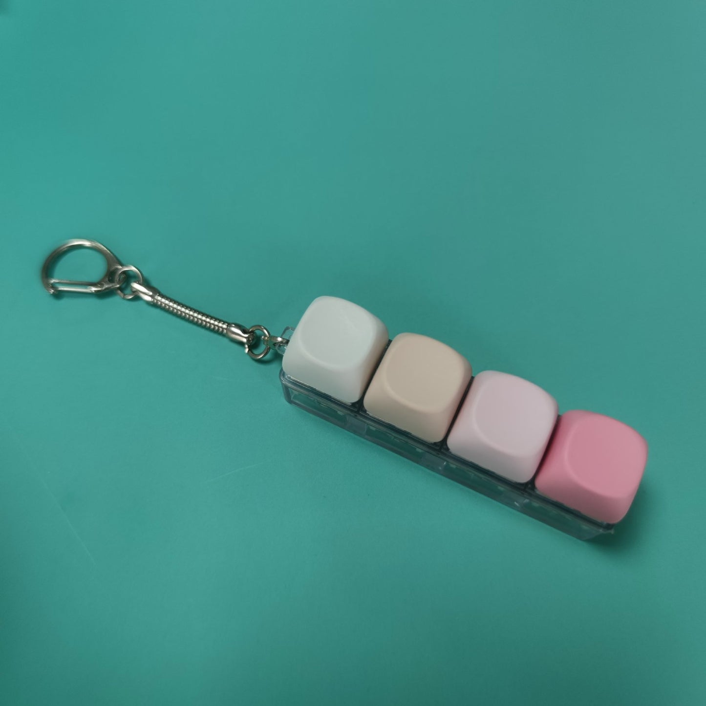 Button-operated stress-relieving toy keychain pendant