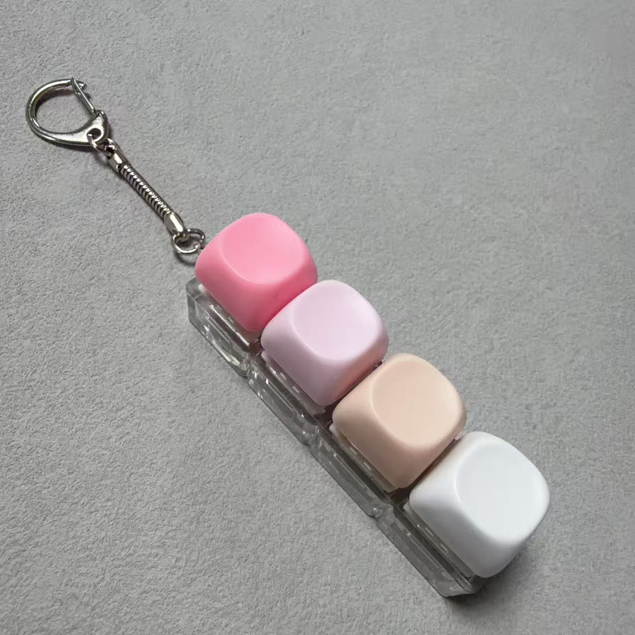 Button-operated stress-relieving toy keychain pendant