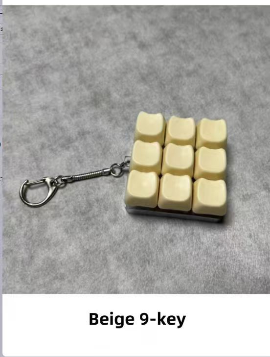 Button-operated stress-relieving toy keychain pendant