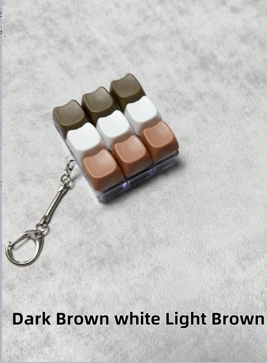 Button-operated stress-relieving toy keychain pendant