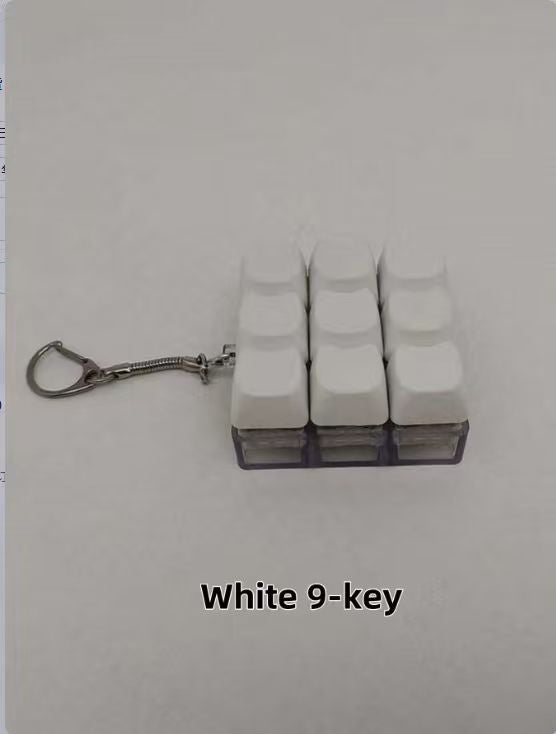 Button-operated stress-relieving toy keychain pendant