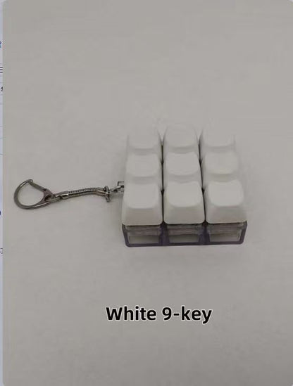 Button-operated stress-relieving toy keychain pendant