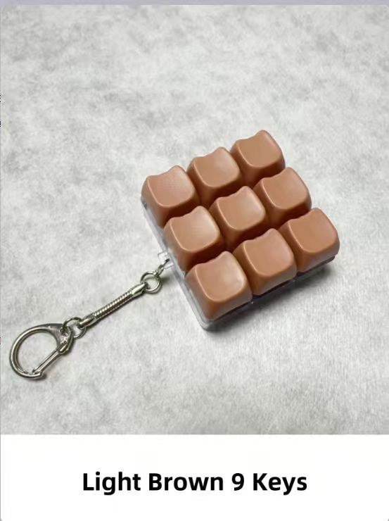 Button-operated stress-relieving toy keychain pendant