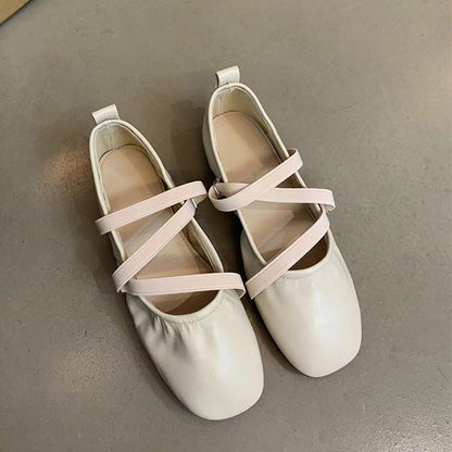 Crossed red Mary Jane ballet shoes