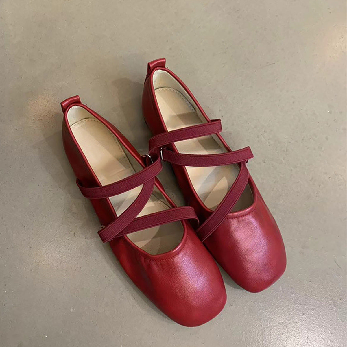 Crossed red Mary Jane ballet shoes