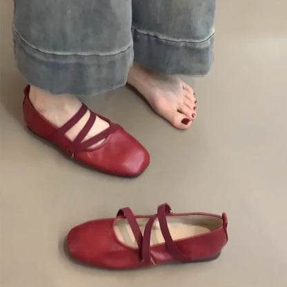 Crossed red Mary Jane ballet shoes