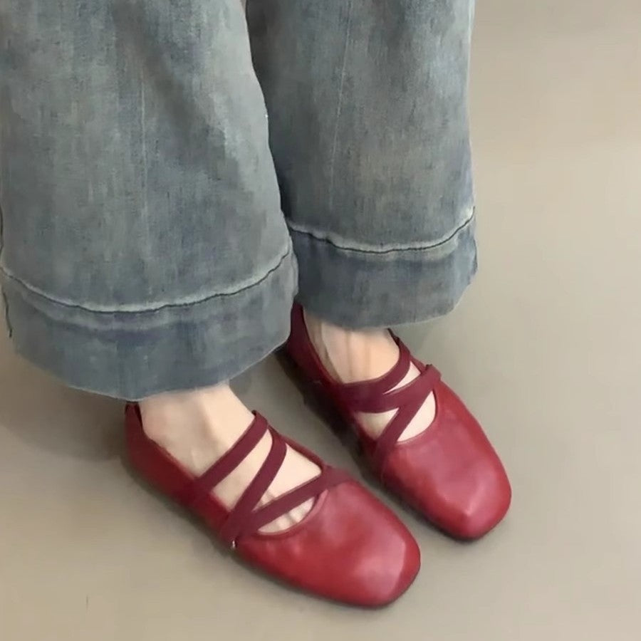 Crossed red Mary Jane ballet shoes