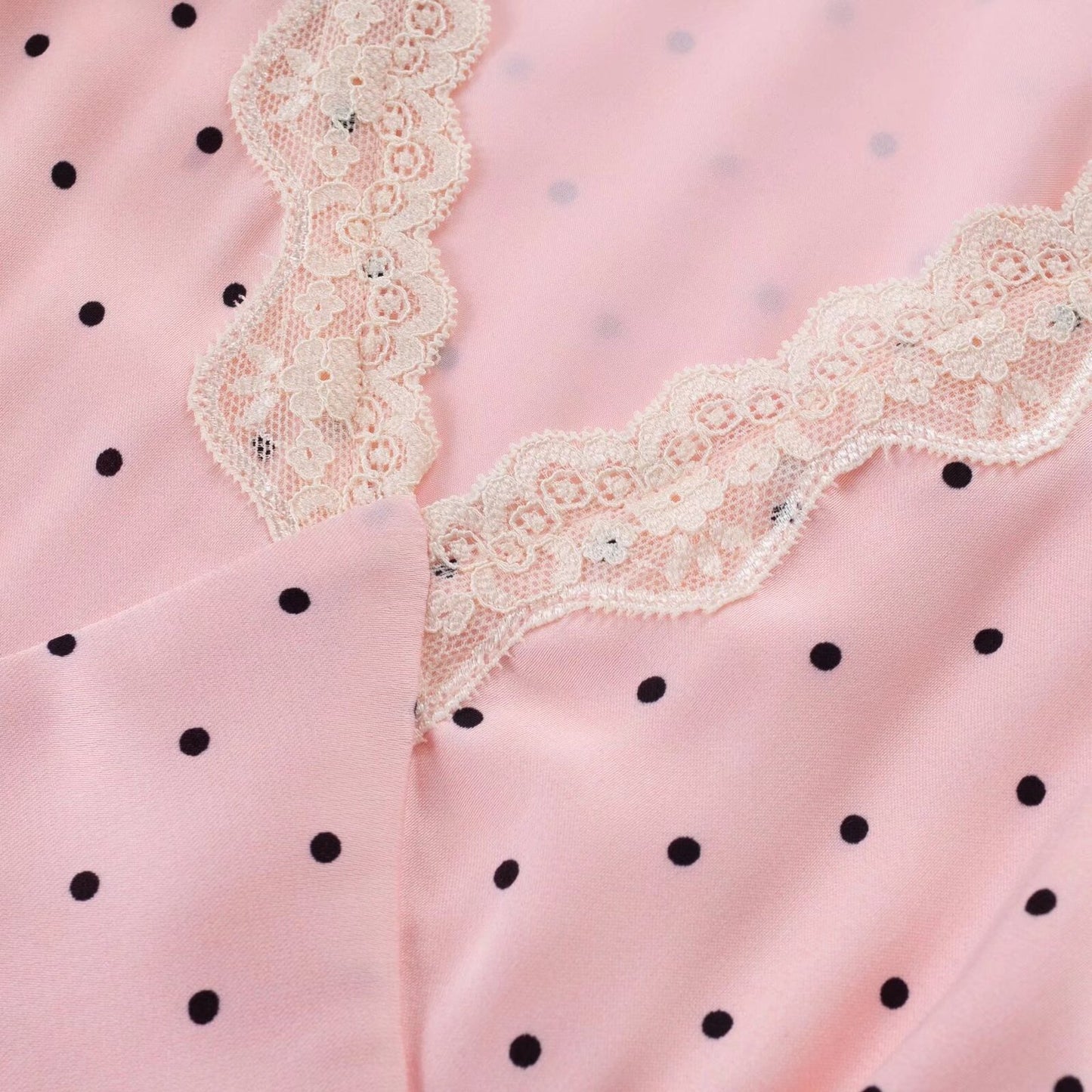 French-style tea party dress in pink with a V-neck, puff sleeves, and polka dots