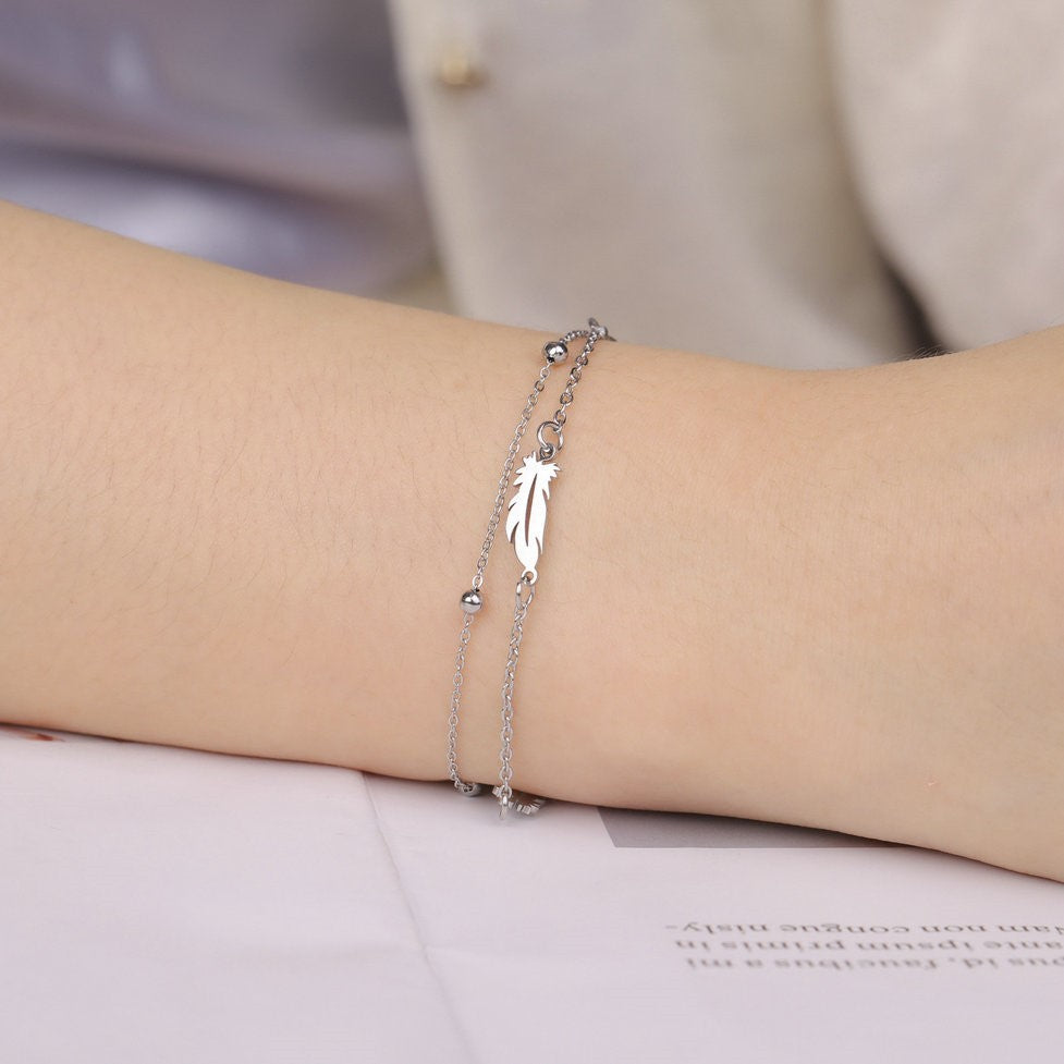 Hollowed-out double-opening feather pendant bracelet