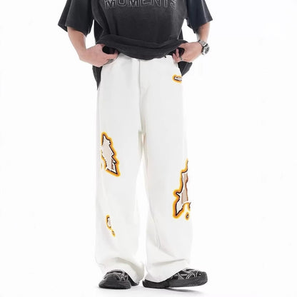 Jeans with hole patches and embroidery