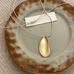 Gold drop pendant necklace