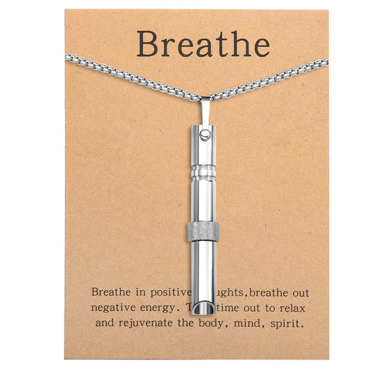 Pendant necklace with titanium and steel whistle