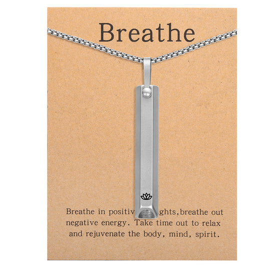 Pendant necklace with titanium and steel whistle