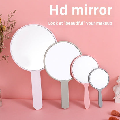 Portable plastic round-handled makeup mirror