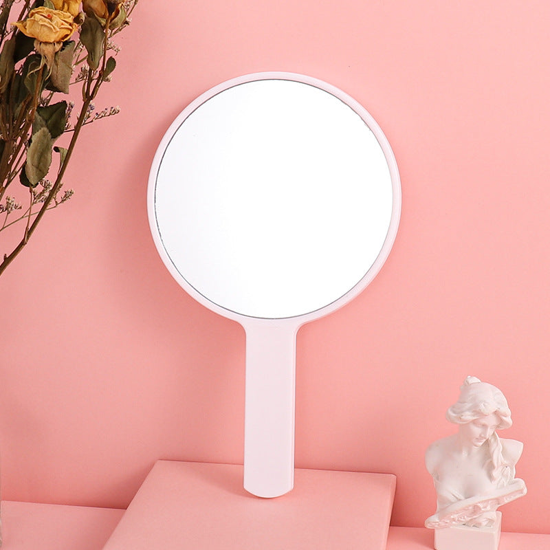 Portable plastic round-handled makeup mirror