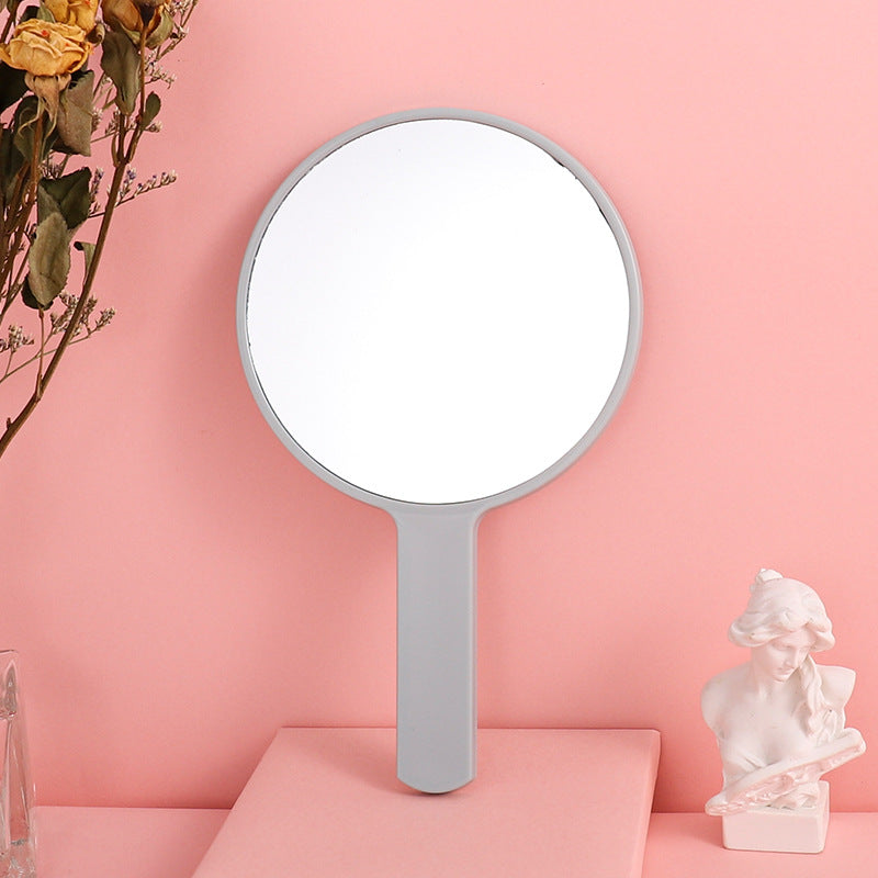Portable plastic round-handled makeup mirror