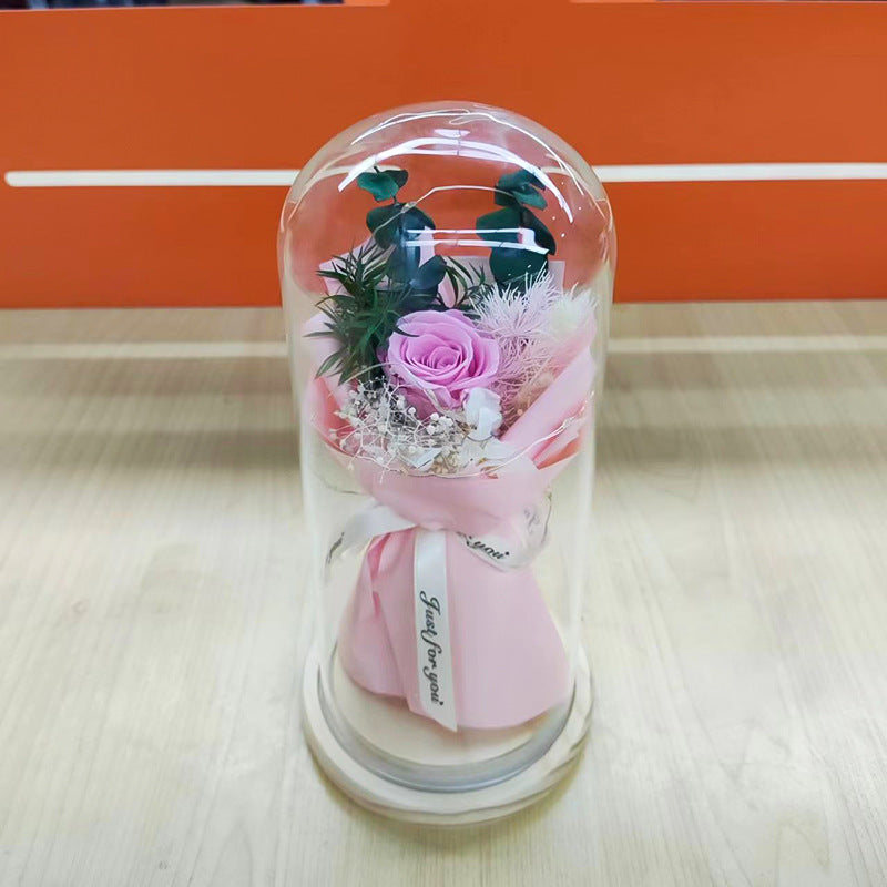 Preserved flower ornament under glass dome
