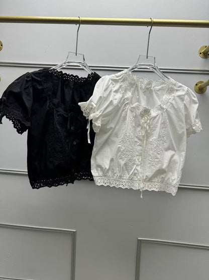 Puff-sleeve blouse with large round neckline, ruffled trim, and tie details