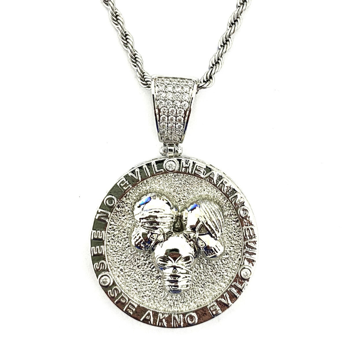 Round disc pendant with three skull heads
