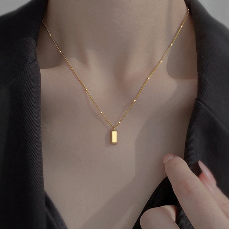 Small gold brick necklace