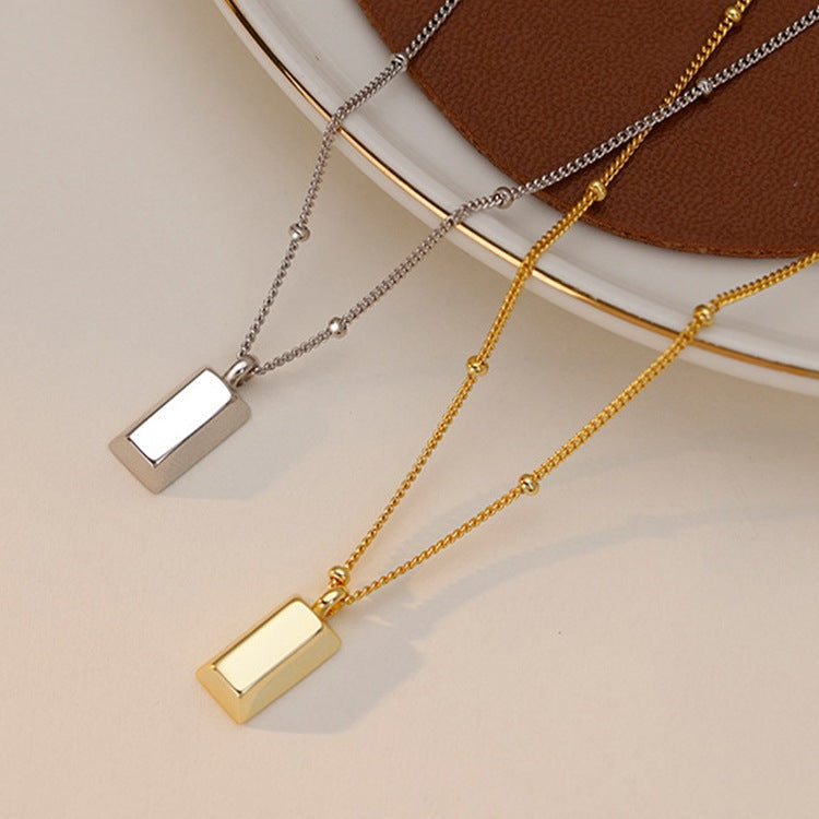 Small gold brick necklace