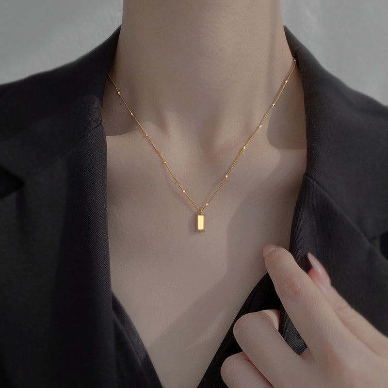 Small gold brick necklace