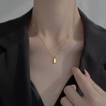 Small gold brick necklace