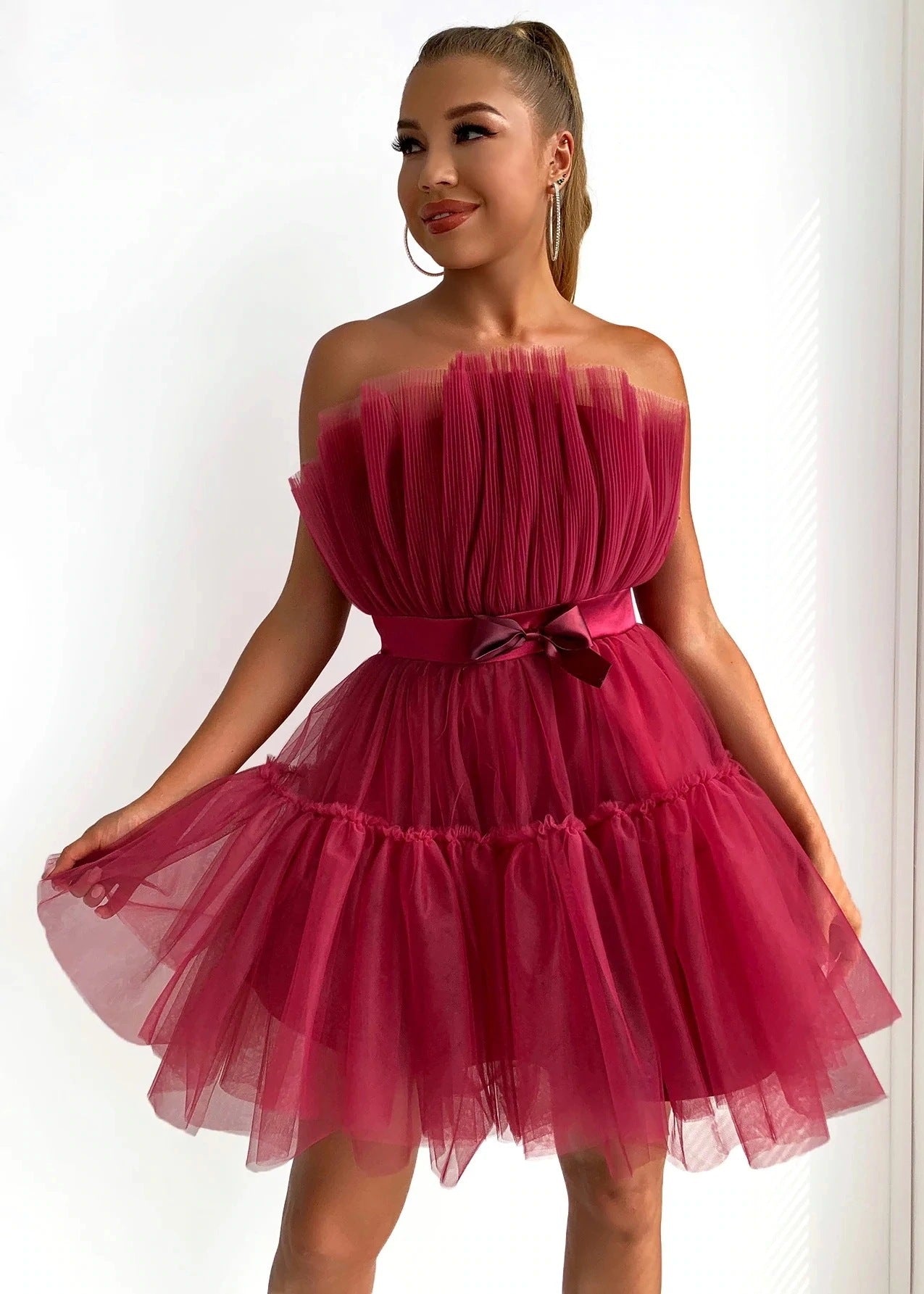 Strapless netted ballgown with bow details and puff sleeves