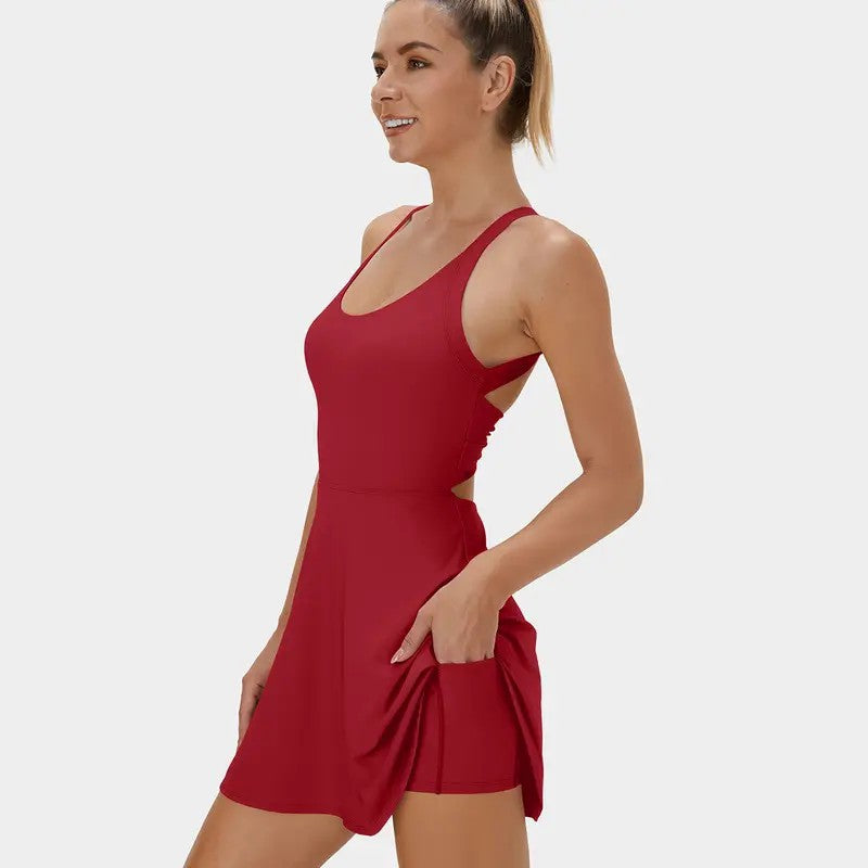 This backless sports dress features a short skirt with built-in shorts and is highly elastic