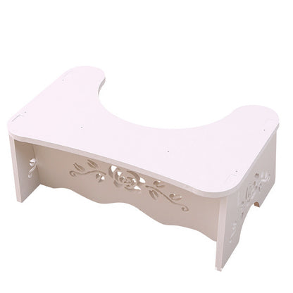 Toilet seat footrest