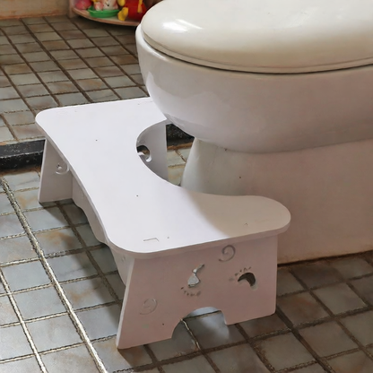 Toilet seat footrest