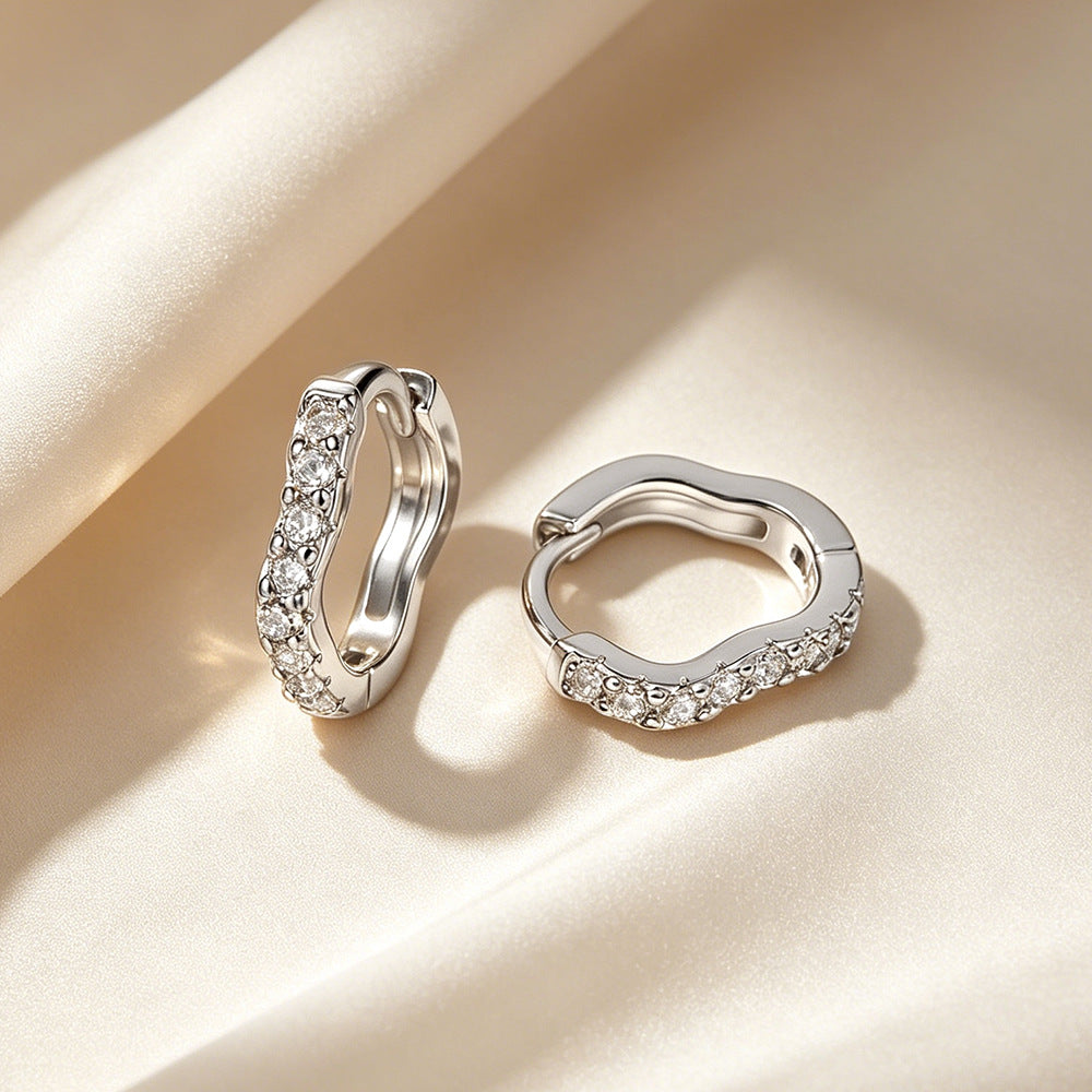 Wave-shaped diamond-studded ear clips