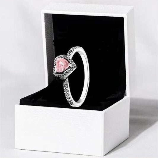 White copper ring with a red heart design