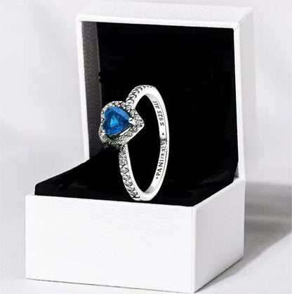 White copper ring with a red heart design