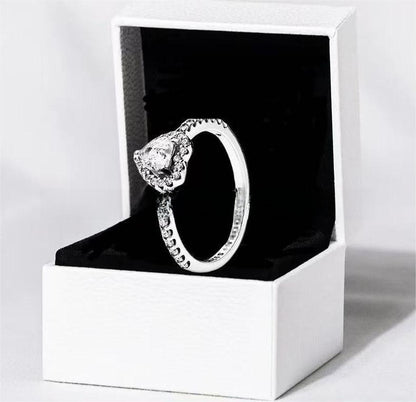 White copper ring with a red heart design