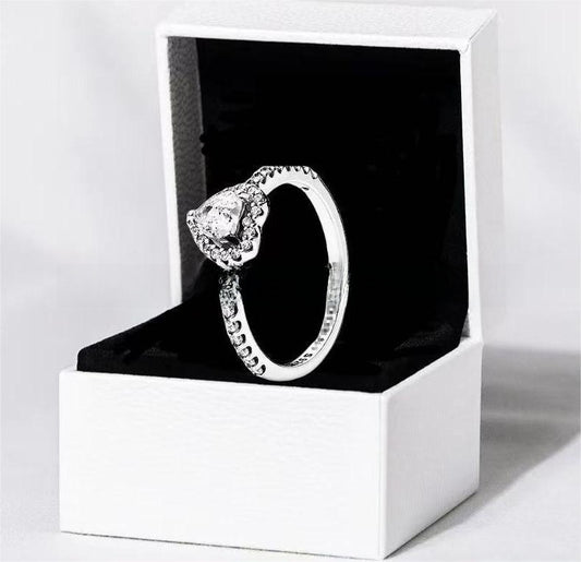 White copper ring with a red heart design