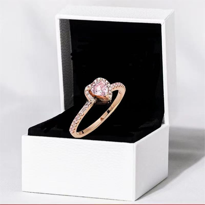 White copper ring with a red heart design