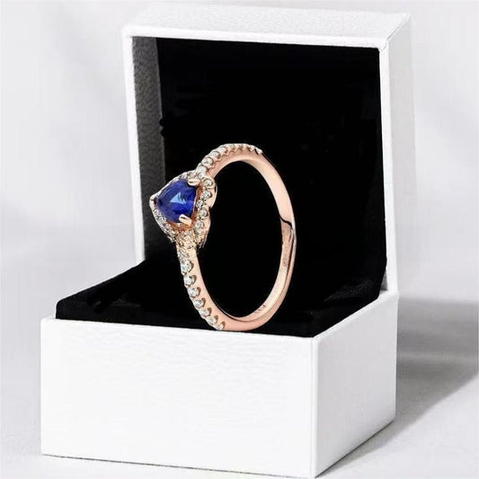 White copper ring with a red heart design