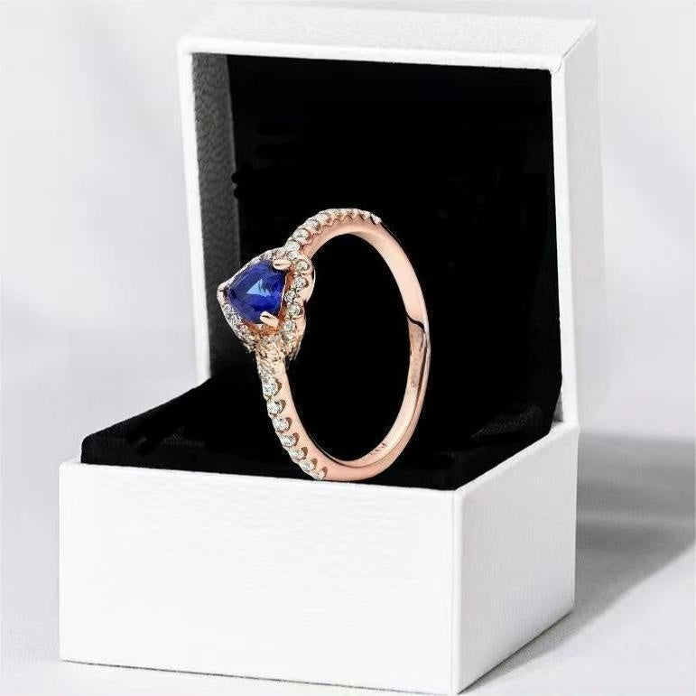 White copper ring with a red heart design