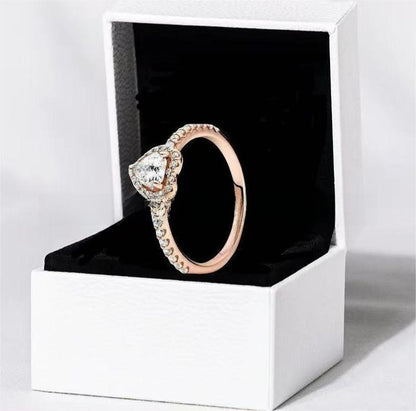 White copper ring with a red heart design