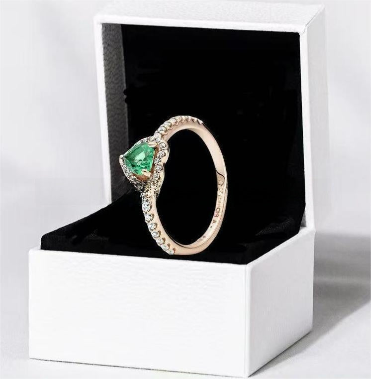 White copper ring with a red heart design