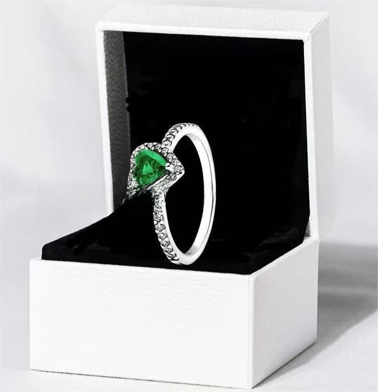 White copper ring with a red heart design